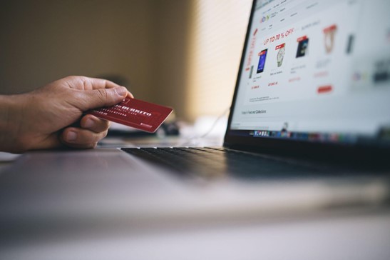 person using credit card to purchase online orders